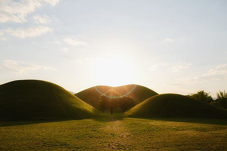 landscape photography of hill during golden hour thumbnail