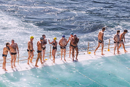 group of people standing on bridge and surrounded by body of water thumbnail