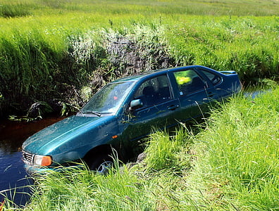 green compact sedan on river thumbnail