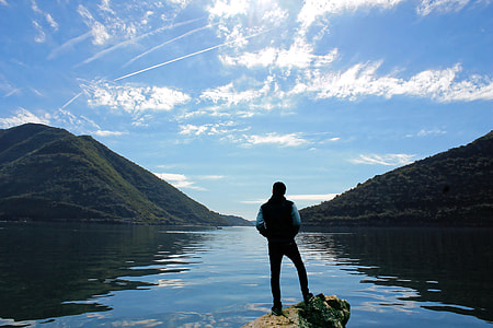 photo of person standing on the rock thumbnail