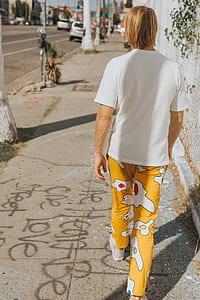 person walking on sidewalk during daytime thumbnail