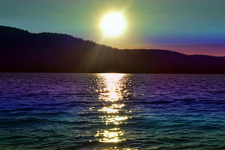 ocean and mountain during sunset photo thumbnail