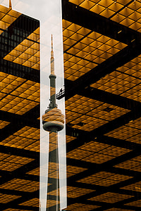 brown tower between brown buildings at daytime thumbnail