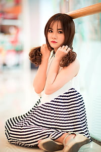 woman sitting beside window thumbnail