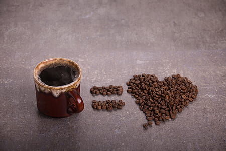 brown ceramic coffee cup near coffee beans thumbnail
