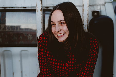woman in black and white check-pattern shirt thumbnail