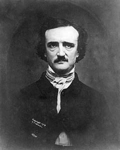 man wearing white scarf and black mandarin-collar suit grayscale portrait thumbnail