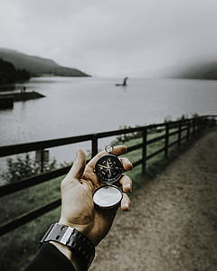 person holding silver-colored pocket watch thumbnail