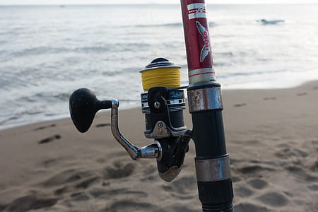 black fishing reel on rod thumbnail