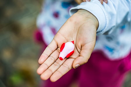 red and pink figure on person palm thumbnail