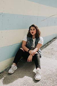 woman wearing pair of white sneakers thumbnail