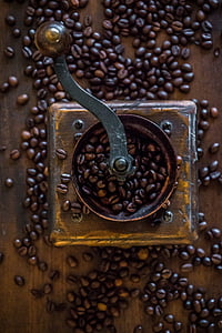 coffee grinder and coffee beans on wood plank thumbnail