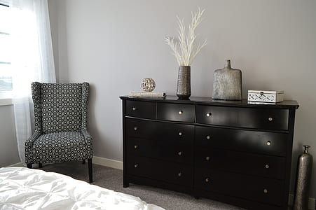 black hemnes lowboy dresser beside gray and black padded wing chair thumbnail