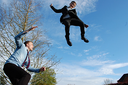 low-angle view of man and kid jumping thumbnail