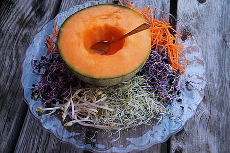slice melon in glass plate on brown wooden surface thumbnail