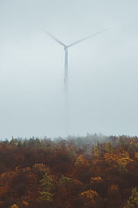 white wind turbine covered with fog thumbnail