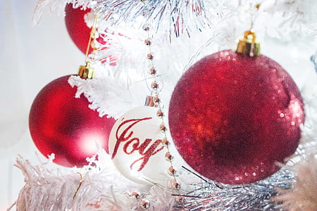 white and red baubles hanging on Christmas tree inside well lighted room thumbnail