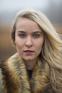 photography of smiling woman wearing brown coat thumbnail