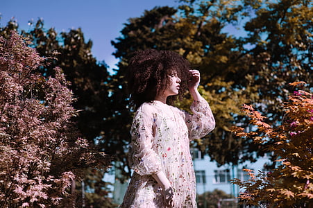 woman standing beside brown leafed tree thumbnail