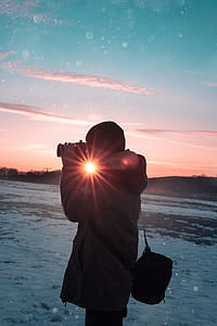 person holding black camera thumbnail