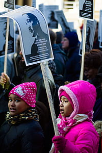 child carrying banner thumbnail