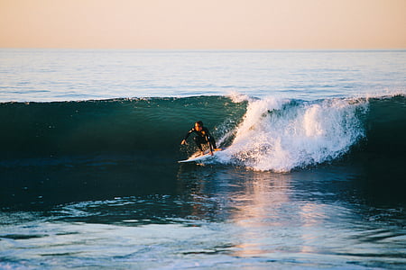 person performing surfing beside ocean waves during daytime thumbnail