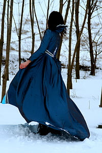 woman in blue dress walking on snow thumbnail