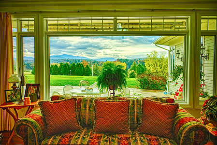red and green fabric 2-seat couch with throw pillows near window frame thumbnail