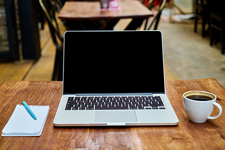 MacBook Pro on brown wooden table-top thumbnail