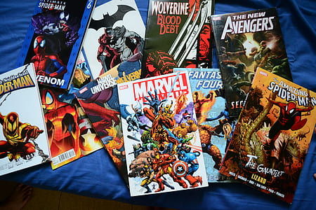 assorted comic book lot on blue textile thumbnail
