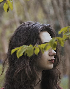 woman's eyes behind leaves thumbnail