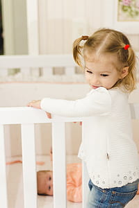 Girl Holding Standing on Crib thumbnail