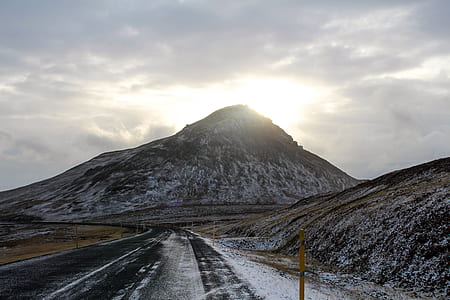 black concrete road between glacier mountain at daytime thumbnail