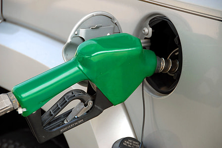 green fuel pump nozzle plugged on vehicle fuel tank thumbnail