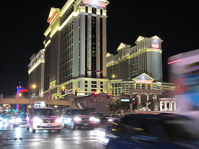 vehicles passing through road under building at daytime thumbnail