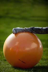 person foot on orange rubber gym ball thumbnail