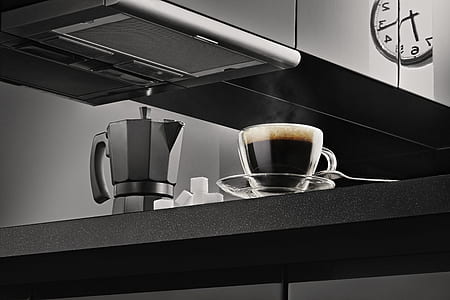 clear glass teacup beside gray moka pot thumbnail