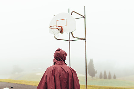 man standing in front of basketball hoop thumbnail