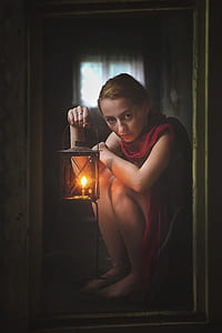 woman sitting on floor holding lantern painting thumbnail