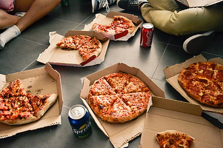 boxes of assorted flavor pizzas placed on floor thumbnail