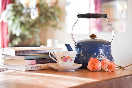 blue steel kettle on top of brown wooden table thumbnail