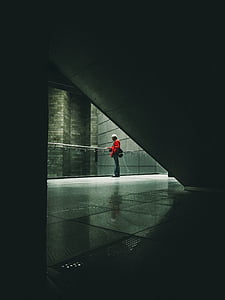 person beside the glass railing inside the building thumbnail