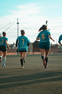 Three Women Wearing Blue Jersey Shirt Running thumbnail