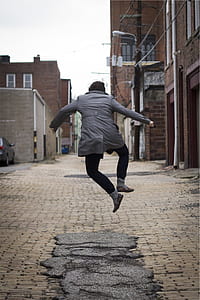 person jumping on gray surface thumbnail