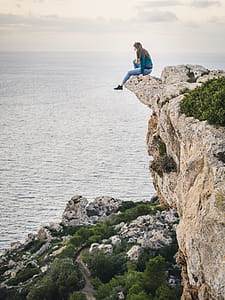 Woman Sitting on Mountain thumbnail