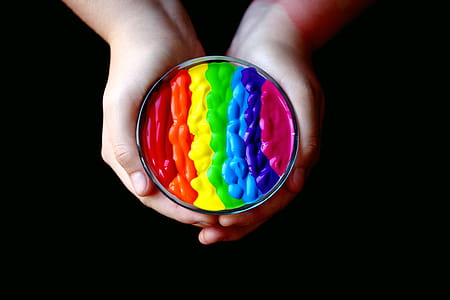 Person Holding Multicolored Container thumbnail