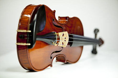 closeup photo of violin on white surface thumbnail