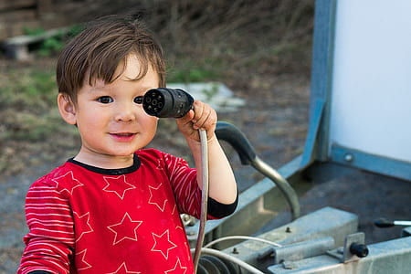 boy holding gray cord thumbnail
