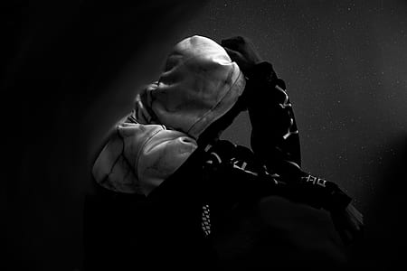 grayscale photography of person wearing hooded jacket thumbnail