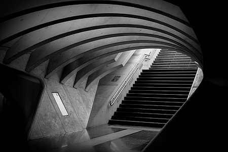 grayscale photo of staircase through tunnel thumbnail